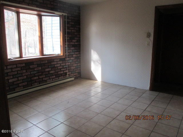 116 Fern Road Dingmans Ferry, PA 18328 - Photo 2 of 5 a view of an empty room and window