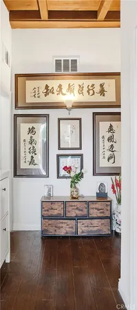a living room with furniture and paintings on the wall