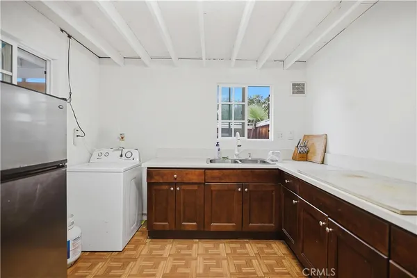 a kitchen with a sink and a refrigerator