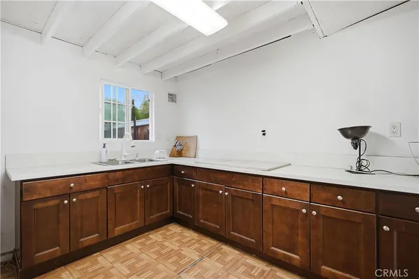 a kitchen with sink and cabinets