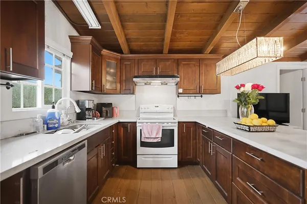 a kitchen with stainless steel appliances granite countertop a sink stove and cabinets