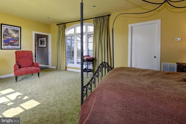 a living room with furniture large window and a fireplace