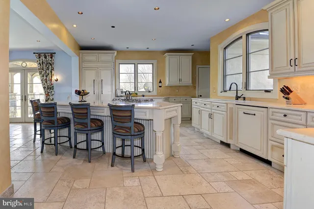 a bedroom with a bed a dresser and next to a window