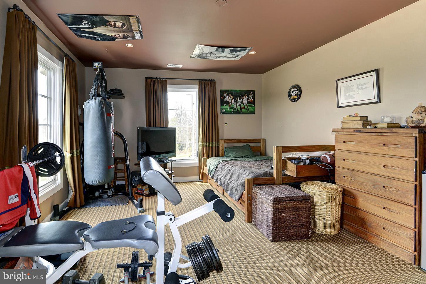 16704 Thurston Road Dickerson, MD 20842 - Photo 58 of 101 a bedroom with furniture and a flat screen tv