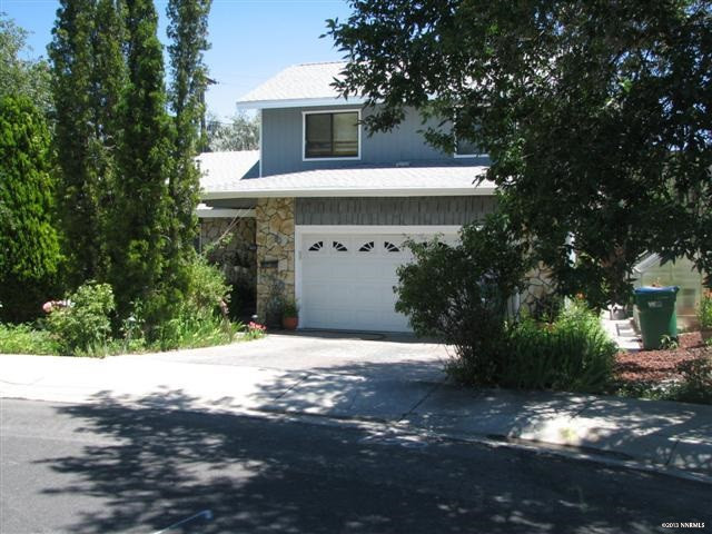 770 Barry M Circle Reno, NV 89503 - Photo 1 of 1 a front view of a house with a yard and garage