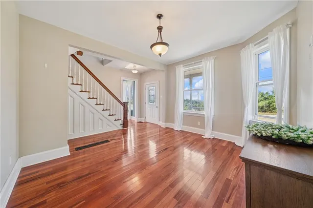 wooden floor in an empty room with a window