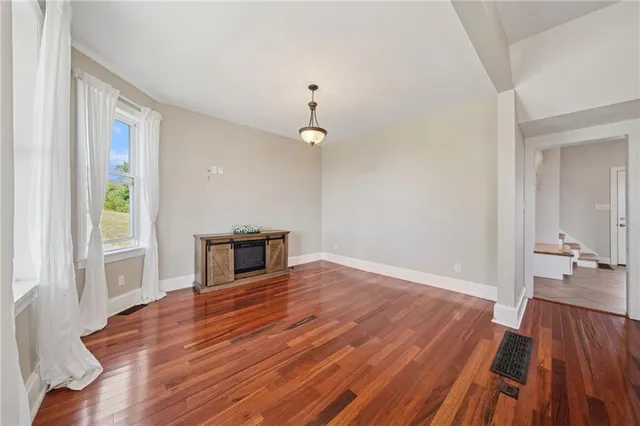 a view of an entryway with wooden floor