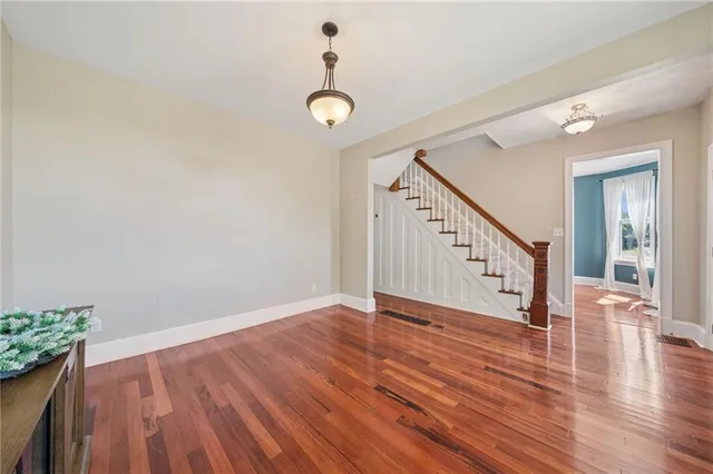 a spacious bathroom with a double vanity sink a large mirror and shower