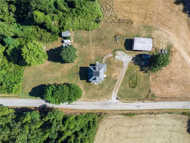 an aerial view of ocean with green space