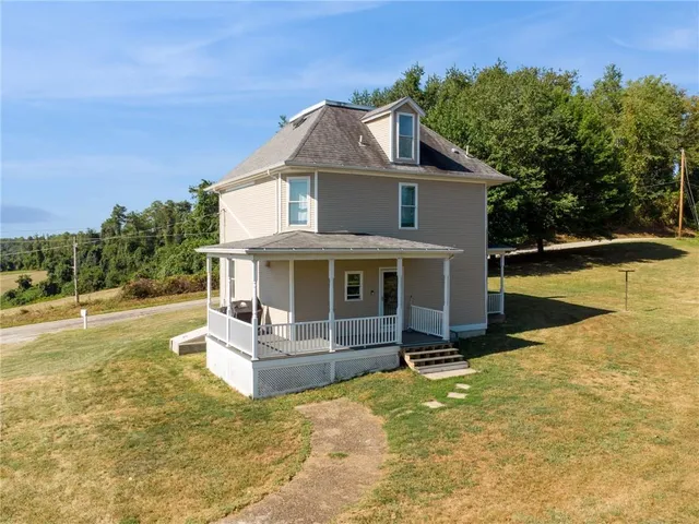a view of a house with swimming pool next to a yard