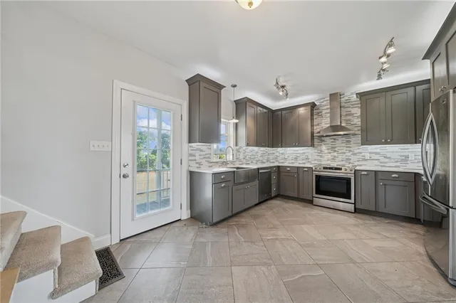 a kitchen with a refrigerator sink and cabinets