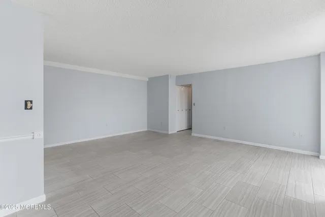 a view of an empty room and wooden floor