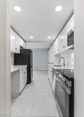 a kitchen with stainless steel appliances granite countertop a sink and a stove top oven