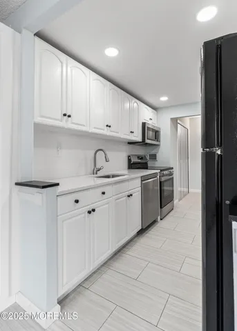 a kitchen with cabinets and stainless steel appliances