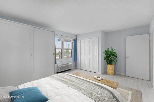 a bedroom with a bed and a potted plant