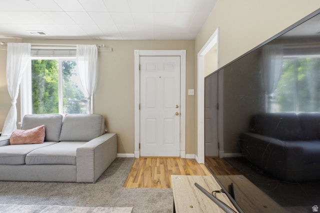 94 West 2000th Street North Clearfield, UT 84015 - Photo 2 of 26 Comfortable living room with front door access, large window, neutral tones, and a cozy layout.