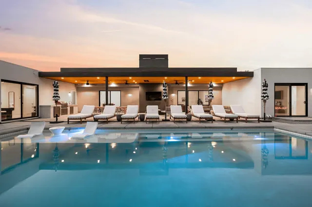 a view of swimming pool and outdoor seating