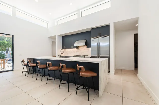 a dining hall with a dining table and chairs