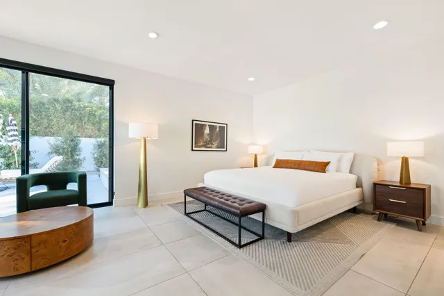 a spacious bedroom with a bed and a large window