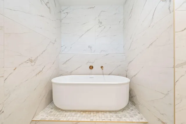 a white bath tub sitting in a bathroom