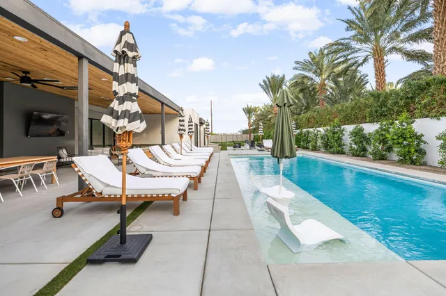 a view of a swimming pool with a yard