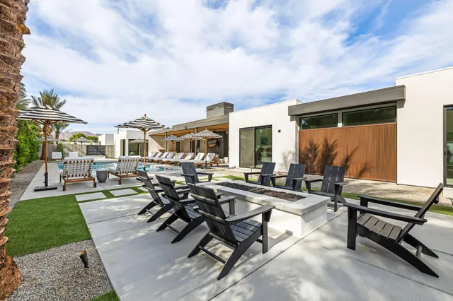 a front view of a house with a garden and yard