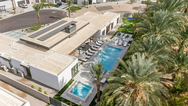 a view of a patio with couches under an umbrella