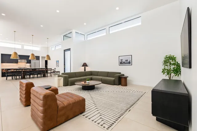 a living room with furniture a lamp and a potted plant