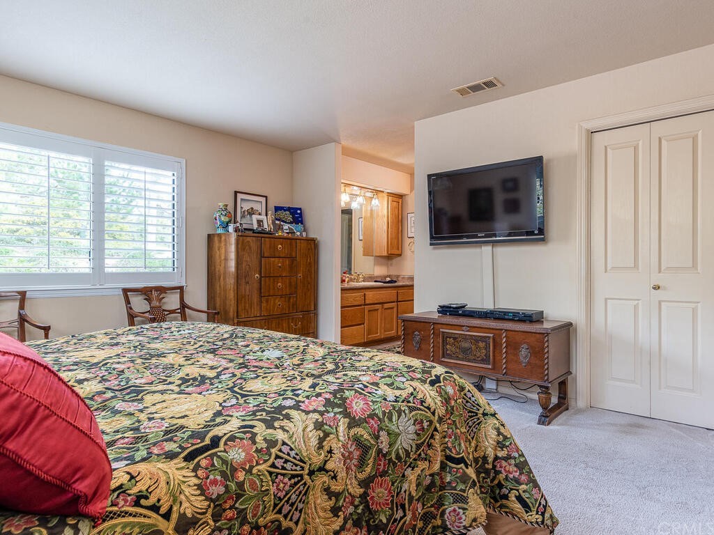 2715 Thoroughbred Place Arroyo Grande, CA 93420 - Photo 14 of 35 a bedroom with a bed and a flat screen tv