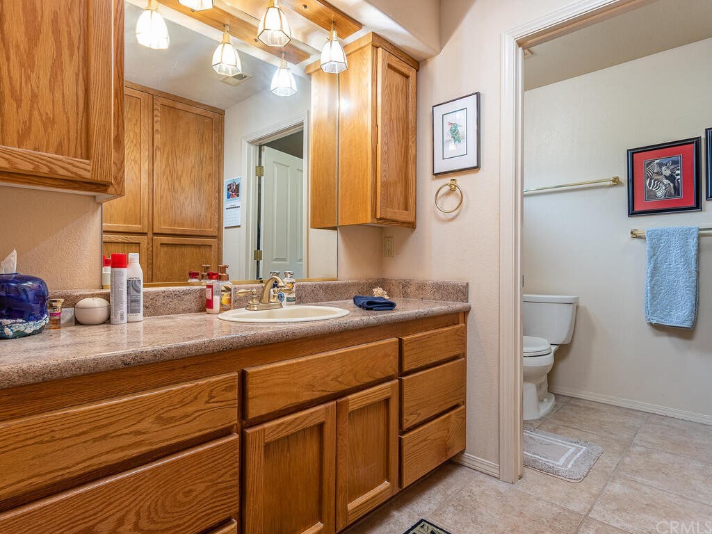 2715 Thoroughbred Place Arroyo Grande, CA 93420 - Photo 15 of 35 a bathroom with a sink a toilet and a mirror