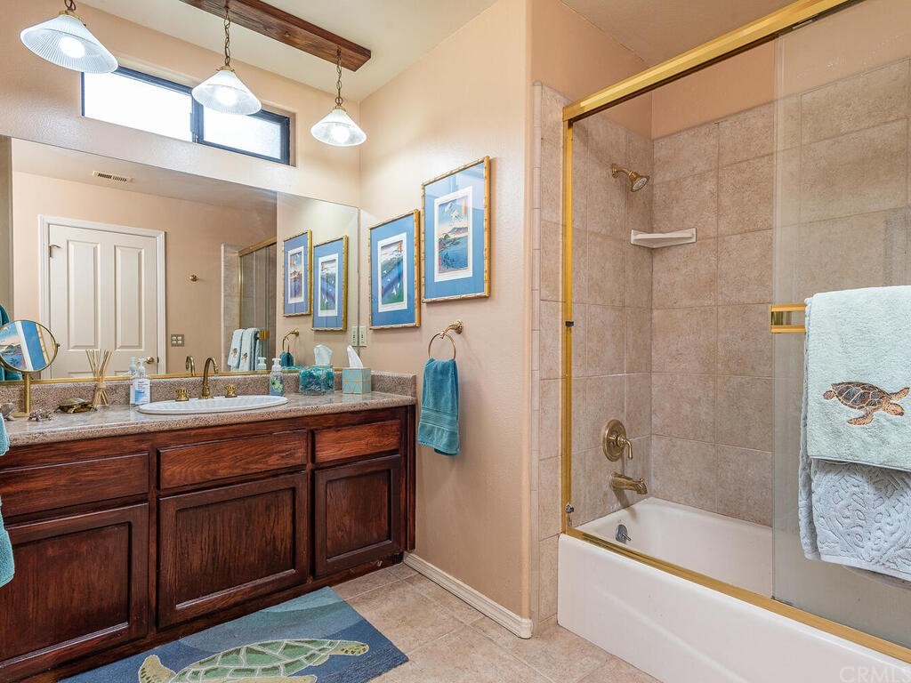 2715 Thoroughbred Place Arroyo Grande, CA 93420 - Photo 20 of 35 a bathroom with a tub sink and mirror