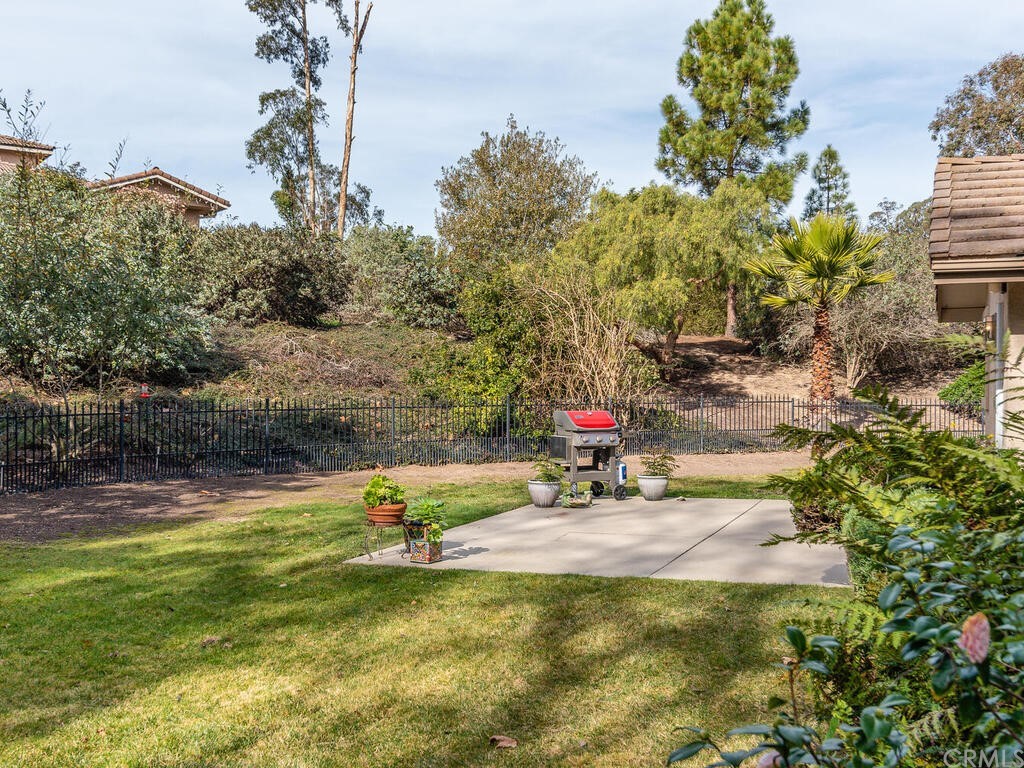 2715 Thoroughbred Place Arroyo Grande, CA 93420 - Photo 24 of 35 a backyard of a house with table and chairs and wooden fence