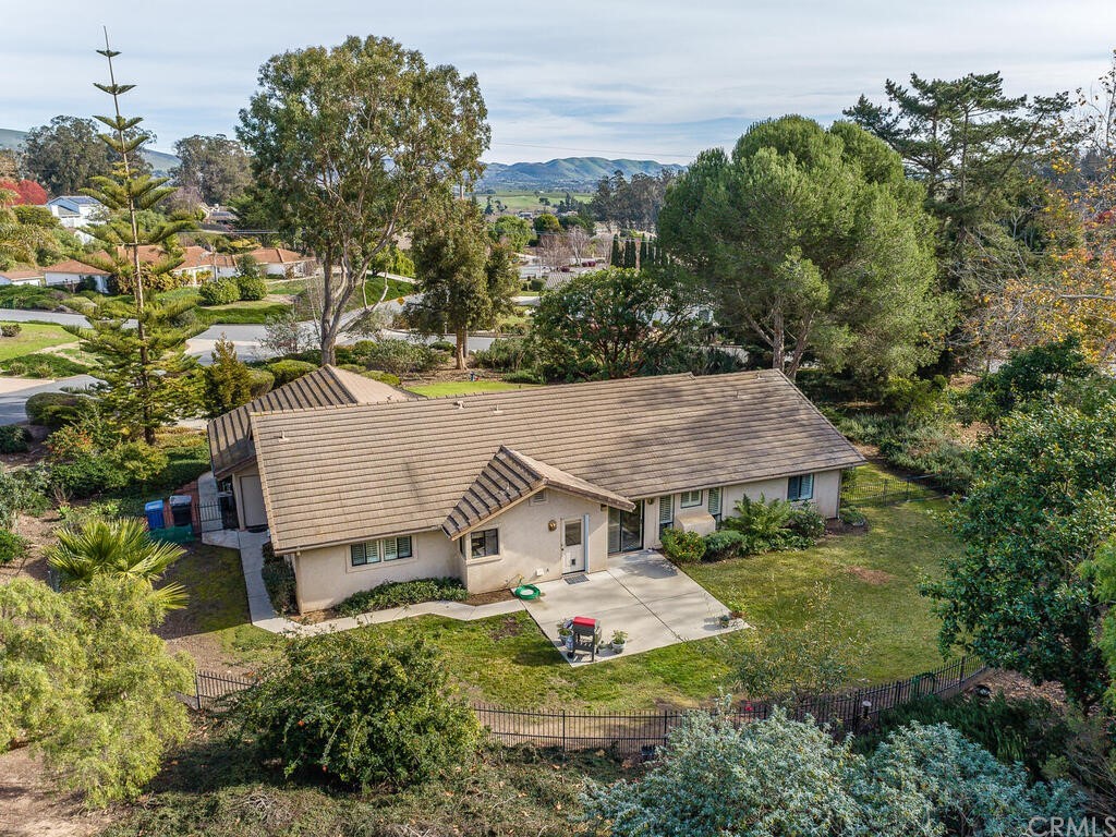2715 Thoroughbred Place Arroyo Grande, CA 93420 - Photo 27 of 35 an aerial view of a house with yard and trees in the background