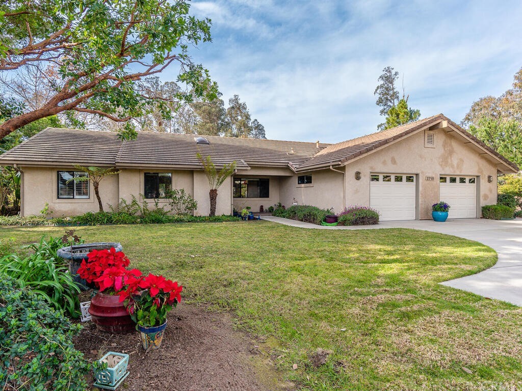 2715 Thoroughbred Place Arroyo Grande, CA 93420 - Photo 4 of 35 a view of a white house with a yard potted plants and large tree