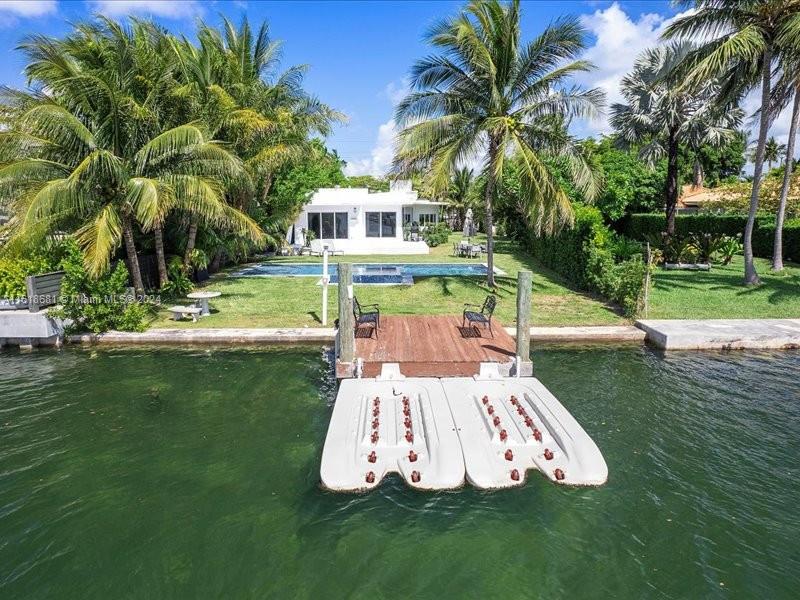 900 88th Street Surfside, FL 33154 - Photo 14 of 60 a view of a swimming pool with a garden