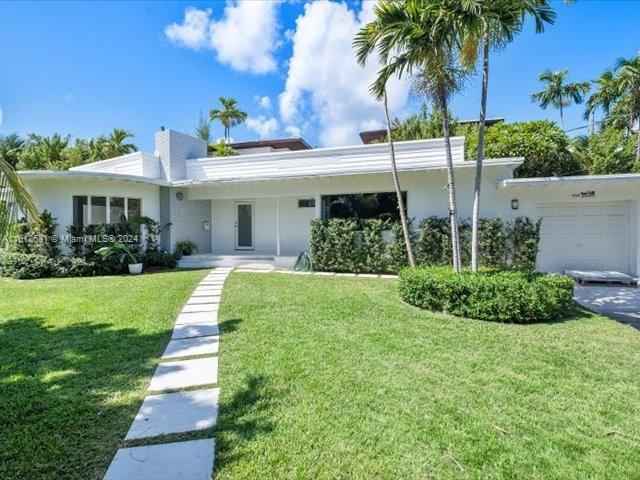 900 88th Street Surfside, FL 33154 - Photo 2 of 60 a view of a house with a yard and potted plants