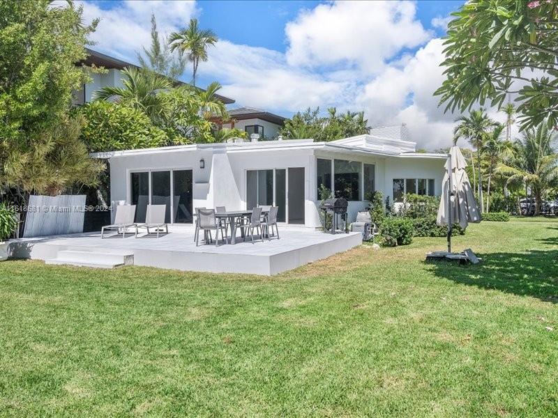 900 88th Street Surfside, FL 33154 - Photo 26 of 60 a view of a house with a backyard porch and sitting area