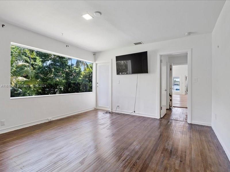 900 88th Street Surfside, FL 33154 - Photo 29 of 60 a view of an empty room with wooden floor and a window