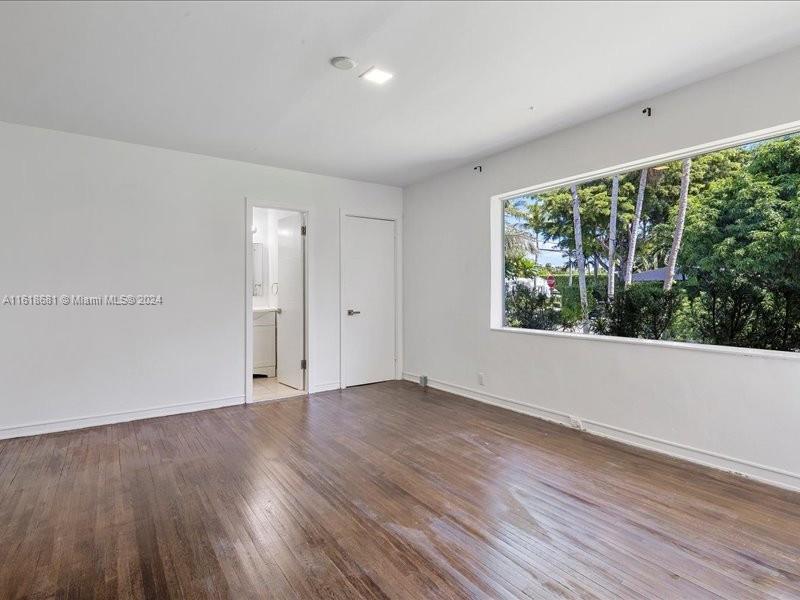 900 88th Street Surfside, FL 33154 - Photo 30 of 60 a view of an empty room with wooden floor and a window