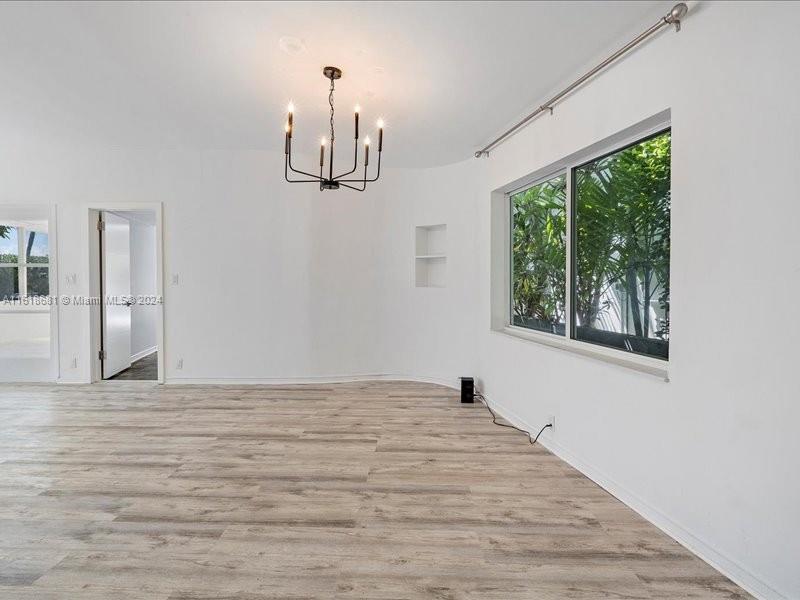 900 88th Street Surfside, FL 33154 - Photo 33 of 60 a view of empty room with wooden floor and fan