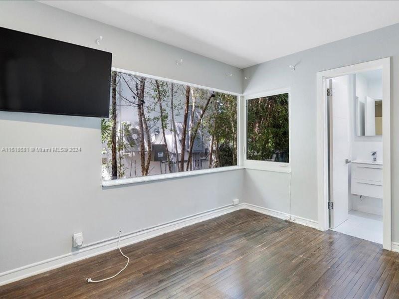 900 88th Street Surfside, FL 33154 - Photo 35 of 60 a view of an empty room with wooden floor and a window