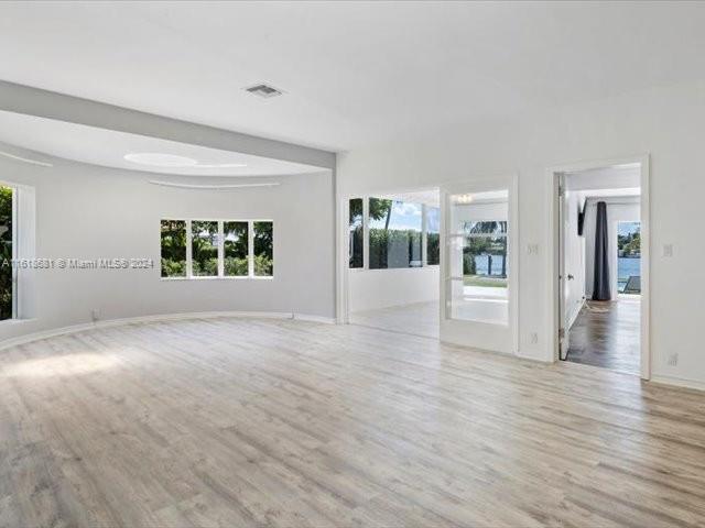 900 88th Street Surfside, FL 33154 - Photo 41 of 60 a view of empty room with wooden floor and fan