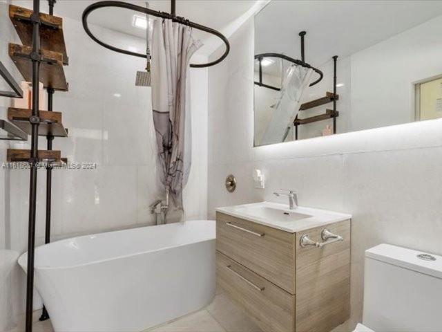 900 88th Street Surfside, FL 33154 - Photo 44 of 60 a bathroom with a sink a vanity and a mirror