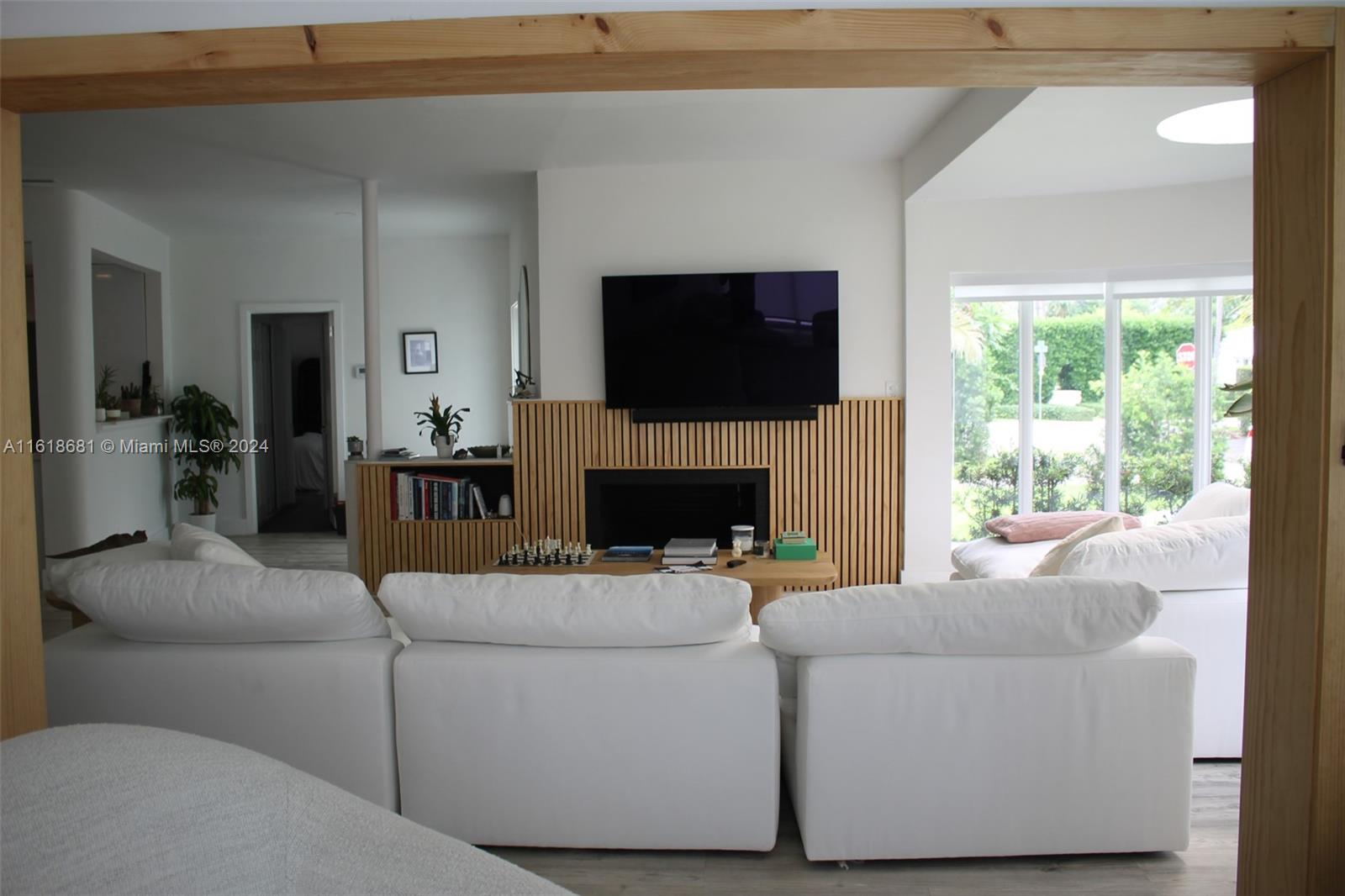900 88th Street Surfside, FL 33154 - Photo 56 of 60 a living room with furniture a flat screen tv and a fireplace