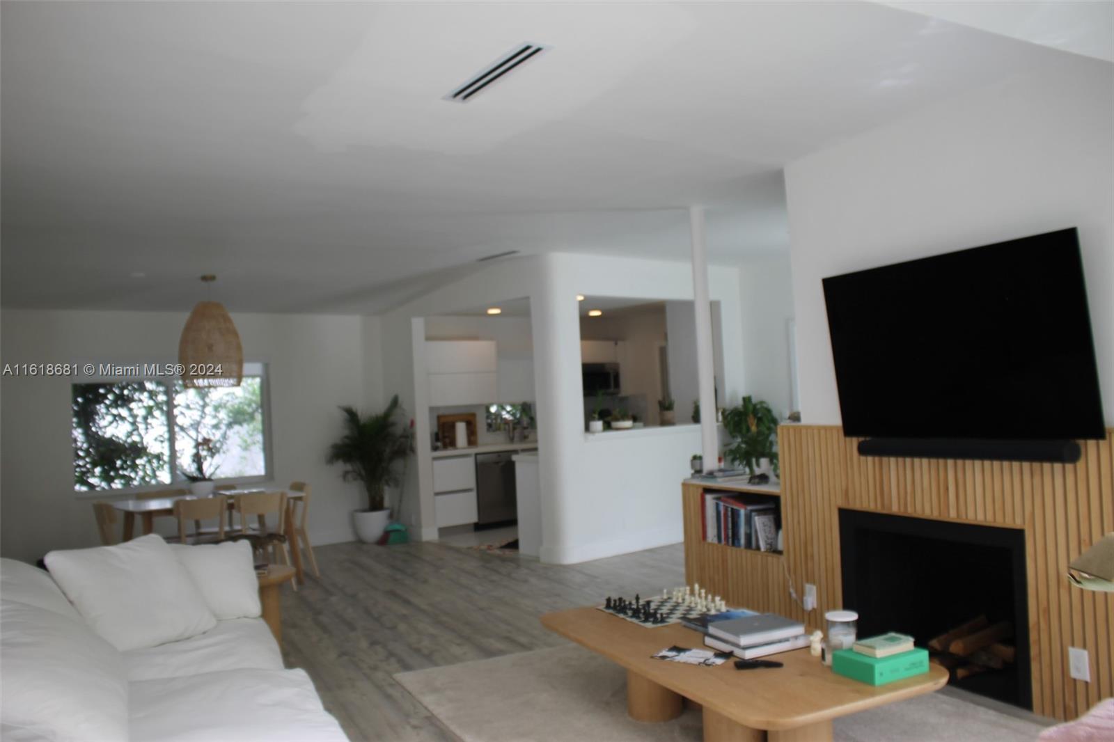 900 88th Street Surfside, FL 33154 - Photo 57 of 60 a living room with furniture a flat screen tv and a fireplace