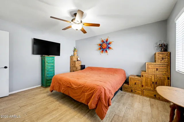 a bedroom with a bed and a flat screen tv