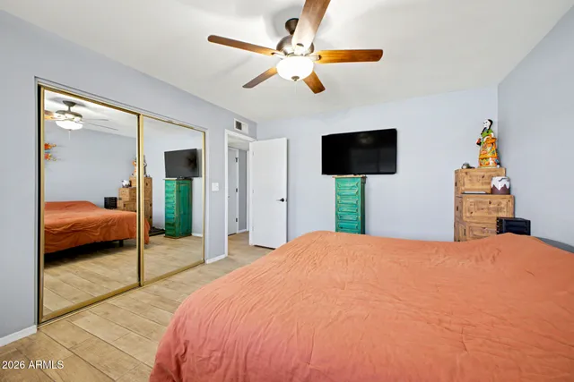 a bedroom with a bed and a chandelier