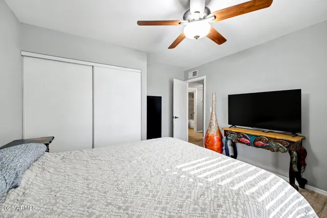 a bedroom with a bed and a flat screen tv