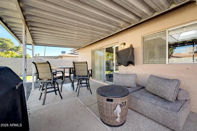 swimming pool view with a garden and seating area