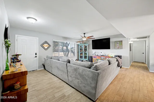 a living room with furniture and a flat screen tv